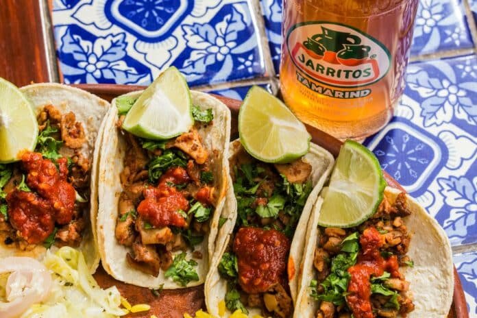 Platillos tradicionales mexicanos norteños con cabrito asado, gorditas y tortillas de harina en mesa rústica, representan los platillos típicos de Saltillo Coahuila